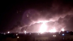 Fires burn in the distance after a drone strike on Saudi company Aramco's oil-processing facilities, in Buqayq, Saudi Arabia, Sept. 14, 2019, in this still image taken from a social media video obtained by Reuters.