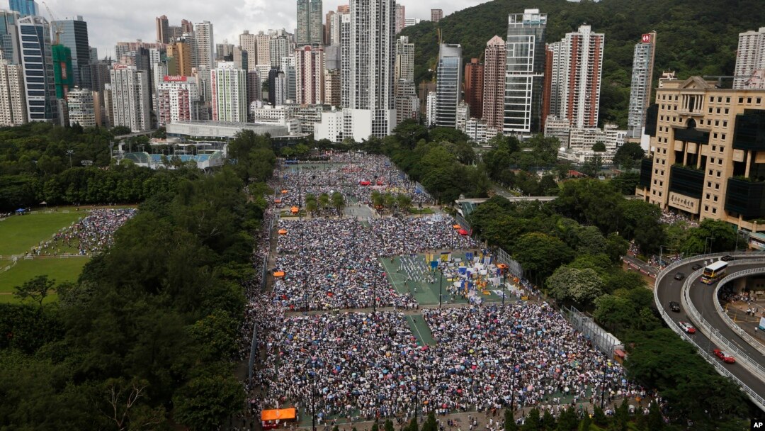 Tens of thousands of residents gather to march in downtown streets during an annual pro-democracy protest in Hong Kong Tuesday, July 1, 2014. Hong Kong residents began marching through the streets of the former British colony to push for greater democracy