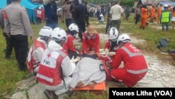 Personel Palang Merah Indonesia (PMI) melakukan evakuasi dan perawatan korban dalam kegiatan simulasi darurat bencana banjir bandang dan gempa bumi di Sigi, Sulawesi Tengah, pada 27 Oktober 2021. (Foto: VOA/Yoanes Litha)