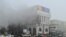 FILE - A view shows smoke billowing from inside a building that houses several TV and radio stations following the protests triggered by fuel price increase, in Almaty, Kazakhstan, Jan. 6, 2022. 