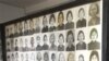 A tourist walks past photos of former prisoners displayed at Tuol Sleng genocide museum, a former Khmer Rouge prison known as S-21, in Phnom Penh.