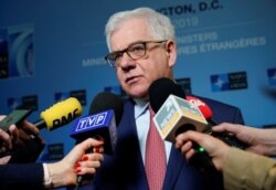 FILE - Polish Foreign Minister Jacek Czaputowicz speaks to the media during the NATO Foreign Minister's Meeting at the State Department in Washington, April 4, 2019.