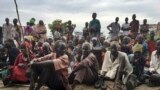 FILE - South Sudanese, displaced by conflict that has raged since late 2013, are seen outside of a U.N. protected camp, in Bentiu, South Sudan, June 18, 2017.