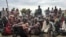 FILE - South Sudanese, displaced by conflict that has raged since late 2013, are seen outside of a U.N. protected camp, in Bentiu, South Sudan, June 18, 2017.