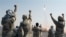 FILE - Iranian Revolutionary Guards celebrate after a missile is launched in Iran, July 3, 2012. Kurdish rebels on Friday clashed with Iran's Revolutionary Guards for a second consecutive day in a border area between Iraq and Iran.