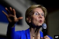 FILE - Then-Democratic presidential candidate Sen. Elizabeth Warren, D-Mass., campaigns in Exeter, N.H., Nov. 11, 2019. Warren proposed a wealth tax that put her at odds with some of Wall Street’s weathiest people.