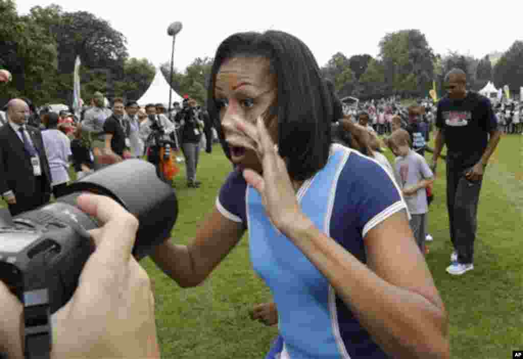U.S. first lady Michelle Obama plays with schoolchildren during a 'Let's Move!' event for about 1,000 American military children and American and British students at the U.S. ambassador's residence in London, ahead of the 2012 Summer Olympics, Friday, Jul