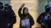 Israeli soldier Agam Berger waves to the crowd as she is handed over to the Red Cross by masked Islamic Jihad militants at the Jabalya refugee camp in Gaza City, Jan. 30, 2025.