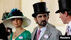 FILE - Jordanian Princess Haya bint Al-Hussein and her husband, Dubai ruler Sheikh Mohammed bin Rashid al-Maktoum, walk to the parade ring on Ladies Day, the third day of horse racing at Royal Ascot, in southern England, June 17, 2010.