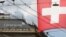 FILE PHOTO: Switzerland's national flag flies in front of the headquarters of Swiss bank Credit Suisse in Zurich