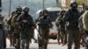 Israeli forces search for a Palestinian gunman in the village of Bruqin near the West Bank town of Salfit, March 17, 2019. 