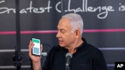 Israeli Prime Minister Benjamin Netanyahu speaks at a fitness center ahead of its reopening in Petah Tikva, Israel, Feb. 20, 2021. He said those fully vaccinated against COVID-19 can get “green badges” that allow more freedom of movement and access.