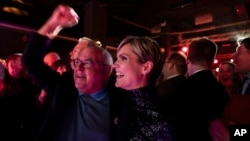 Kristrún Mjöll Frostadóttir, leader of the Samfylking, Social Democratic party, right, celebrates with a supporter at the celebration party following the closure of the polling stations in Reykjavik, Nov. 30, 2024. 