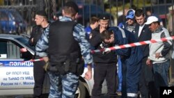 Police investigators work at the site of a brawl at the Khovanskoye cemetery in Moscow, Russia, May 14, 2016.