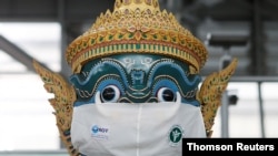 A Thai traditional giant statue wears a protective mask, amid the coronavirus disease (COVID-19) pandemic, at Suvarnabhumi Airport in Bangkok, Thailand Dec. 15, 2020.