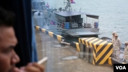 FILE: A journalist looks out from a bus over a jetty mooring patrol boat during a rare media tour at Ream Naval Base in Preah Sihanouk province, Friday, July 26, 2019. (Sophat Soeung/VOA Khmer)