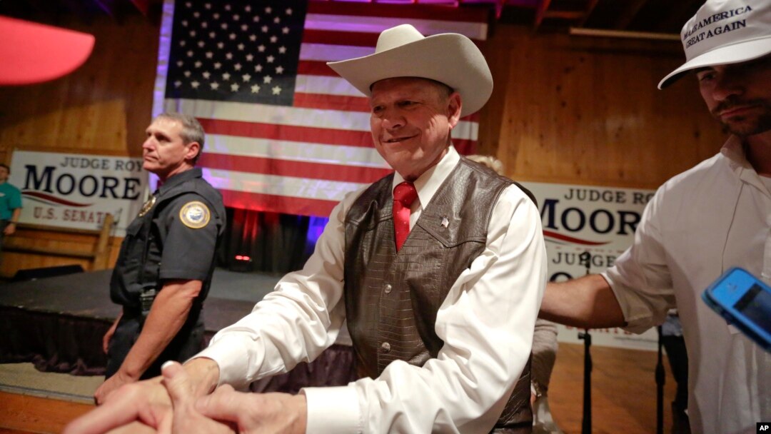 FILE - Former Alabama chief justice and U.S. Senate candidate Roy Moore shakes hands with supporters after he speaks at a rally, in Fairhope, Alabama, Sept. 25, 2017.