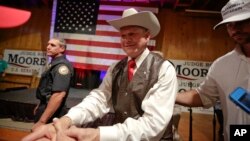 FILE - Former Alabama chief justice and U.S. Senate candidate Roy Moore shakes hands with supporters after he speaks at a rally, in Fairhope, Alabama, Sept. 25, 2017.