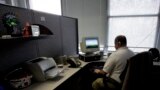 In this Nov. 11, 2010 file photo, 43-year-old Peter Berg who lost his vision to diabetes in his 20s, works at his office in Chicago. Using software that reads content to him, he can surf websites for work, check Facebook and pay his bills online.