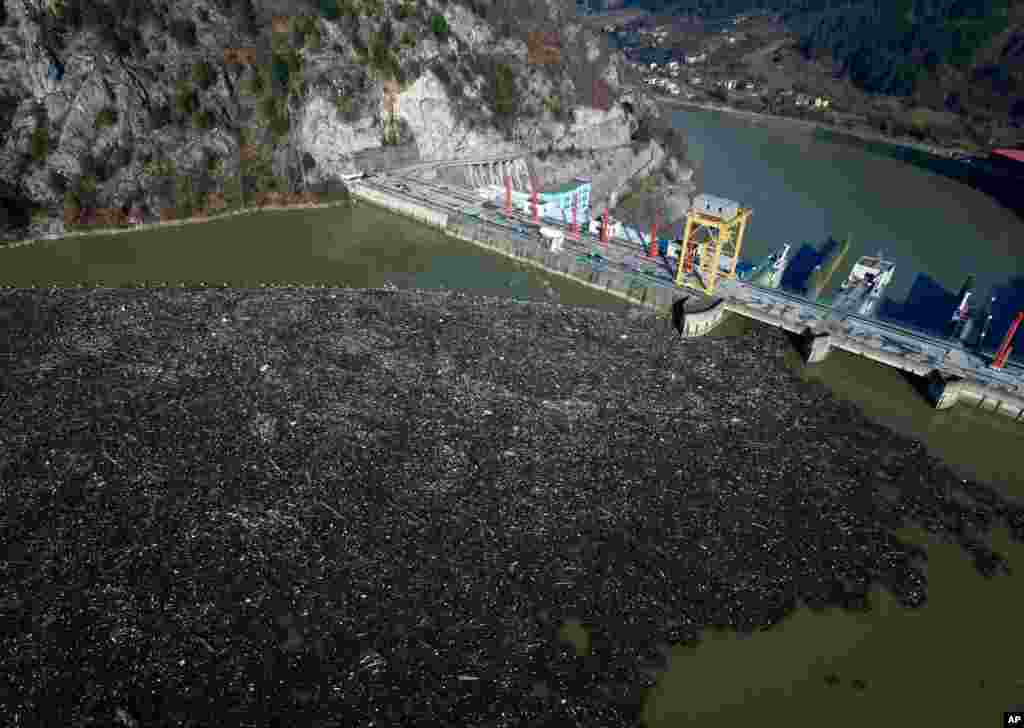 This aerial photo shows plastic bottles, wooden planks, rusty barrels and other garbage clogging the Drina River, near the eastern Bosnian town of Visegrad, Bosnia.