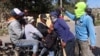 Hooded residents stop people at a checkpoint to check if they carry weapons following days of gang violence, in the Kenscoff neighborhood, in Port-au-Prince, Haiti, Jan. 29, 2025. 