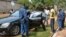 Police officers inspect the vehicle of minister Hafsa Mossi, a close ally of President Pierre Nkurunziza, after she was killed on July 13, 2016 in Burundian capital, Bujumbura. 