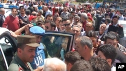 UN observer and Syrian army officer, listen to Syrian citizens . (AP Photo/SANA)