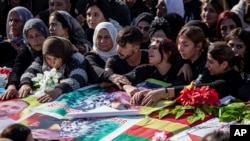 Syrian Kurds attend a funeral of people killed in Turkish airstrikes in the village of Al Malikiyah, northern Syria, Nov. 21, 2022.