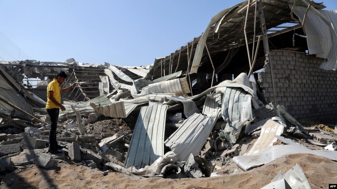 FILE - A Yemeni man inspects destruction at a charity's destroyed food aid storage facility, following a reporteded Saudi-led coalition airstrike in the Yemeni port city of Hodeidah, December 23, 2017.