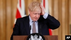 Britain's Prime Minister Boris Johnson reacts during a press conference at Downing Street on the government's coronavirus action plan in London, March 3, 2020.