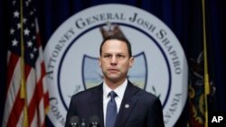 FILE - Pennsylvania Attorney General Josh Shapiro speaks during a news conference at the Capitol in Harrisburg, Pa., Aug. 14, 2018. The office of Shapiro says the report on East Stroudsburg University Vice President Isaac Sanders remains subject to an 8-year-old confidentiality agreement and can't be released.