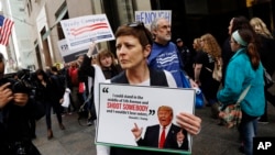 Protesters, organized by The Brady Campaign to Prevent Gun Violence, stage a "die-in" in front of Trump Tower, the residence of Republican presidential candidate Donald Trump, March 16, 2016, in New York. 