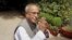 Indian Finance Minister Pranab Mukherjee gestures as he arrives for the Congress Working Committee (CWC) meeting in New Delhi, India, Monday, June 25, 2012. 