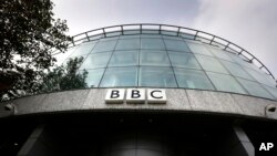 FILE - In this Oct. 24, 2012 file photo, a sign is seen at the entrance to a building at the BBC Television Center, in London.