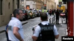 FILE - Police officers, fire fighters and medics are seen near the site of a suspected bomb attack in central Lyon, France, May 24, 2019.