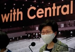 FILE - Hong Kong Chief Executive Carrie Lam listens to reporters' questions during a press conference in Hong Kong, Aug. 7, 2020.