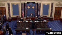 FILE - U.S. House lead impeachment manager Jamie Raskin, D-Md., hands over the article of impeachment against former President Donald Trump, on the floor of the U.S. Senate in this this frame grab from video at the U.S. Capitol, Jan. 25, 2021.