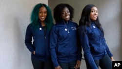 Members of the Nigerian women's bobsled team (L-R), Akuoma Omeoga, Seun Adigun and Ngozi Onwumere, pose for a photograph during an interview with The Associated Press at the 2018 Winter Olympics in Pyeongchang, South Korea, Tuesday, Feb. 13, 2018. 