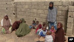 Anak-anak dan istri dari mereka yang diduga anggota sekte Boko Haram di Nigeria, menyusul penggerebekan di Kano. (Foto: Dok)