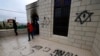 Palestinians inspect the damage done to a mosque, after a reported attack by Israeli settlers, in the town of Marda near the West Bank city of Salfit on Dec. 20, 2024. 