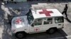 FILE - An Afghan policeman walks past a Red Cross vehicle in Jalalabad, east of Kabul, Afghanistan, May 30, 2013.