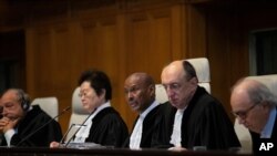 Presiding judge Abdulqawi Ahmed Yusuf and other judges open the first day of three days of hearings in the case brought by Gambia against Myanmar Myanmar's at the International Court of Justice in the Hague, Dec. 10, 2019. 