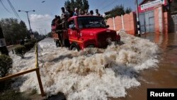 A truck evacuating Kashmiri flood victims to higher ground travels through a flooded street in Srinagar, Sept. 10, 2014. 