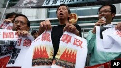 2012年11月8日，香港民主派活動人士在中聯辦前示威﹐並撕開印有一黨專政的海報。