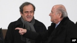 FILE - UEFA president Michel Platini (L) and FIFA president Sepp Blatter are seen in a Dec. 16, 2014, photo.