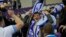 FILE - Israel supporters wave flags during the Euro 2024 qualifying playoff soccer match between Israel and Iceland, at Szusza Ferenc Stadium in Budapest, Hungary, March 21, 2024. 