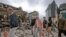 People walk through debris in the aftermath of a 6.3 magnitude earthquake in Christchurch, New Zealand, on February 22, 2011.