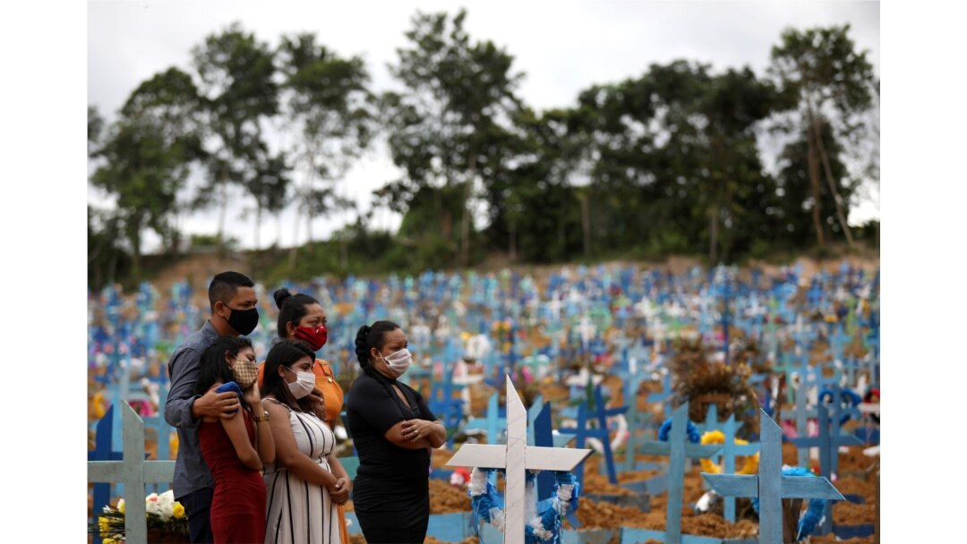 Relatives are seen during a mass burial of people who passed away due to the coronavirus disease, at the Parque Taruma cemetery in Manaus, Brazil, May 26, 2020.