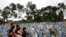 Relatives are seen during a mass burial of people who passed away due to the coronavirus disease, at the Parque Taruma cemetery in Manaus, Brazil.