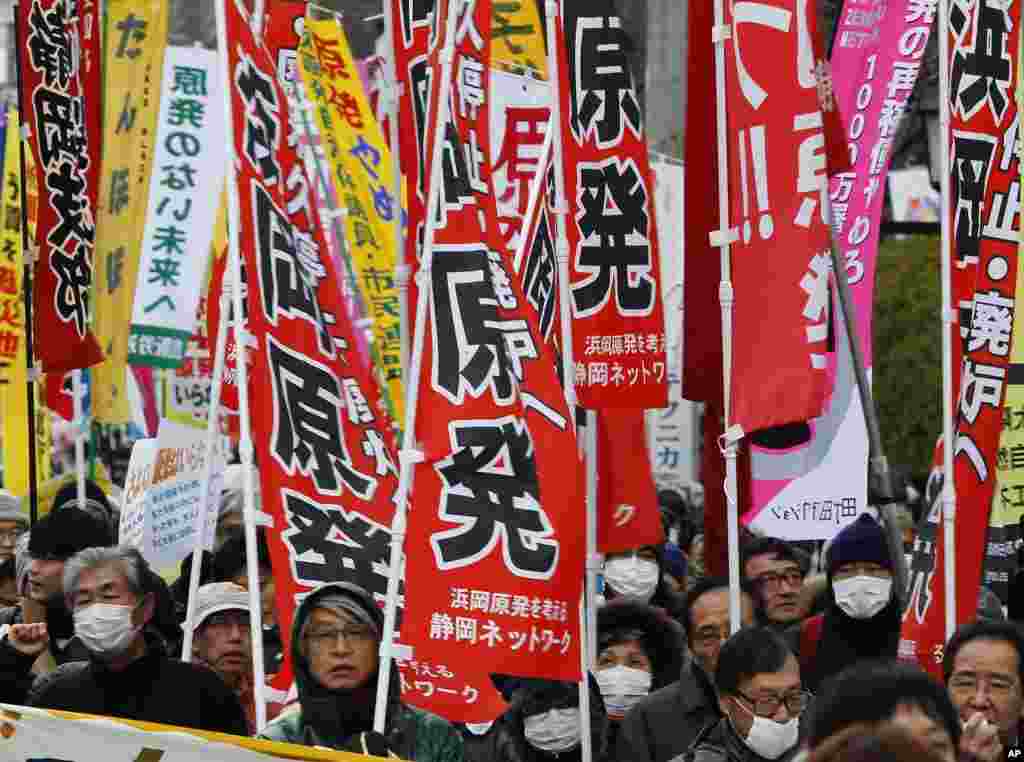 Demonstrators holding banners march during an anti-nuclear protest in Koriyama, Fukushima prefecture March 11, 2012. (Reuters)